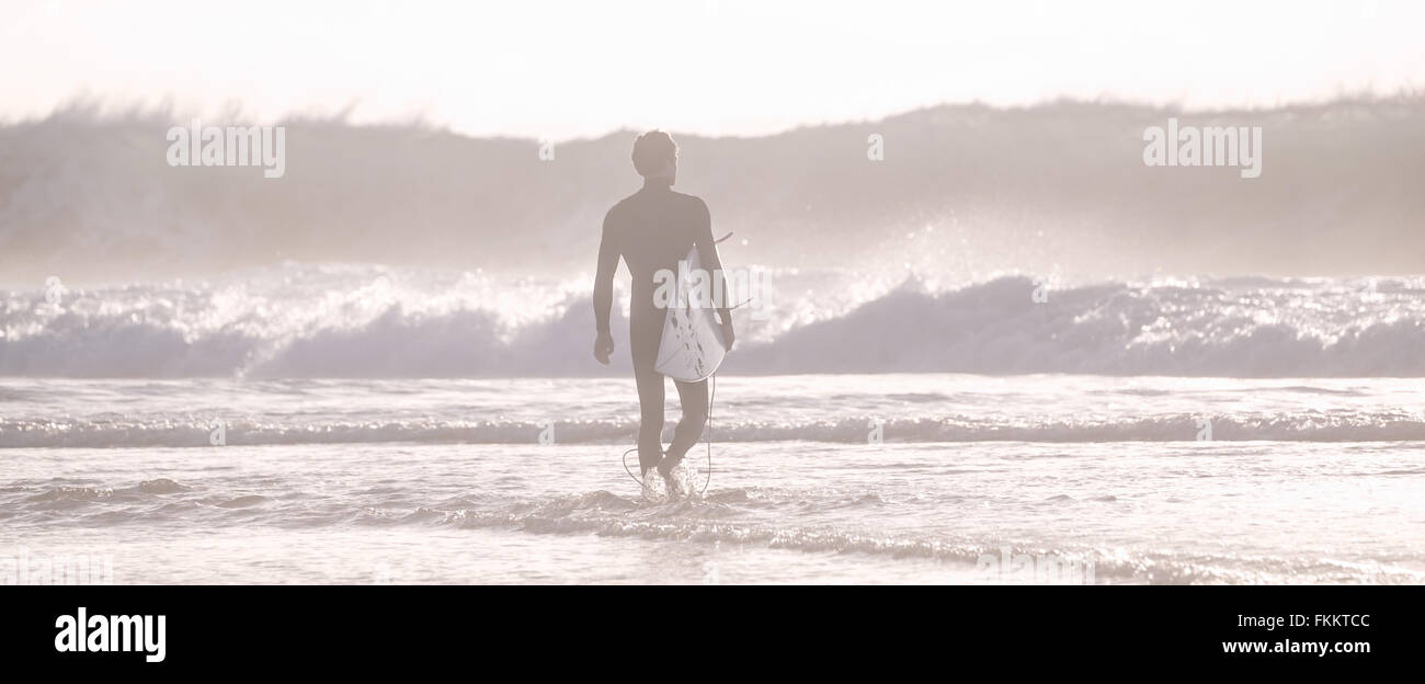 Silhouette of surfer on beach with surfboard Stock Photo - Alamy