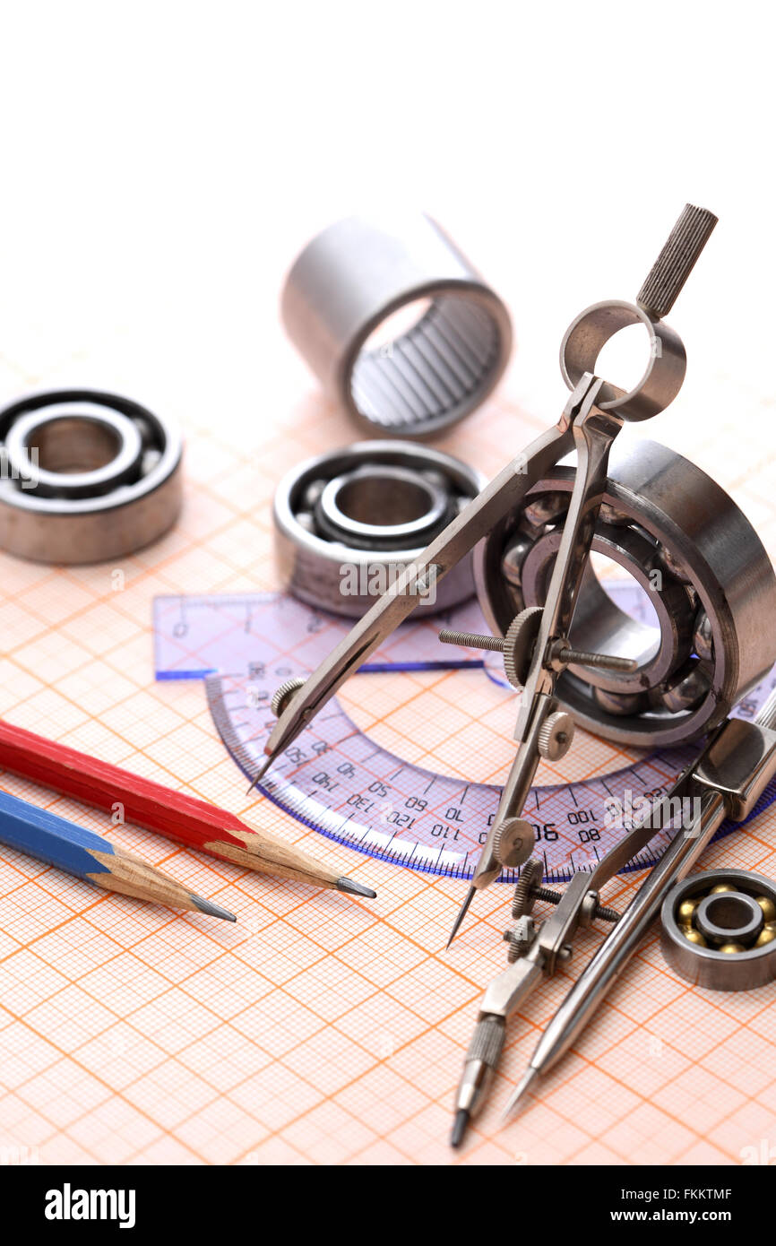 Industrial concept. Drawing instrument near ball bearings on graph