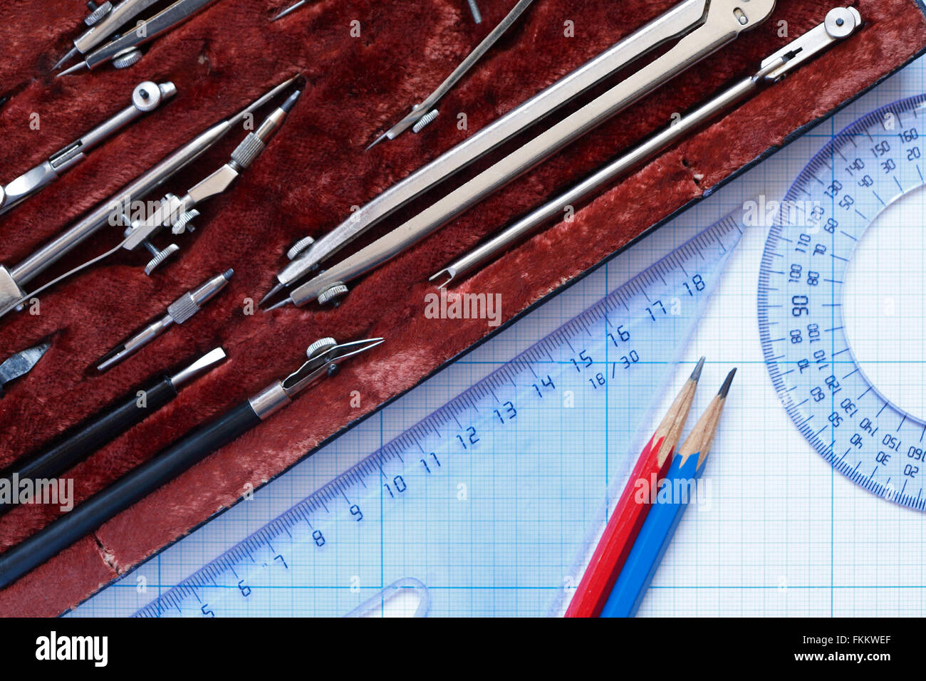 Set of drawing instrument in box and rulers on graph paper Stock Photo ...