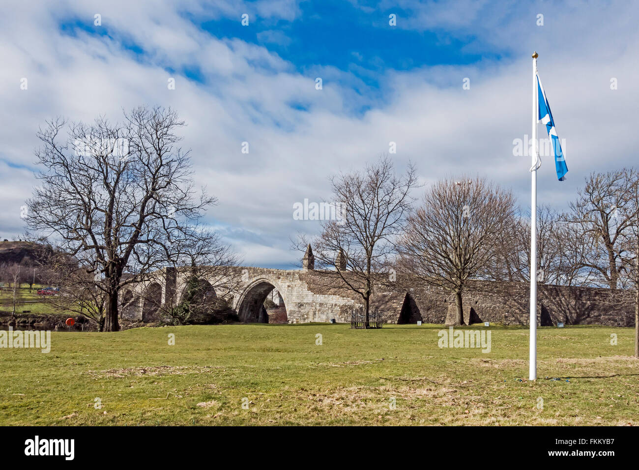 Stirling Old Bridge crossing the River Forth at Stirling in Scotland with battlefield and flag Stock Photo