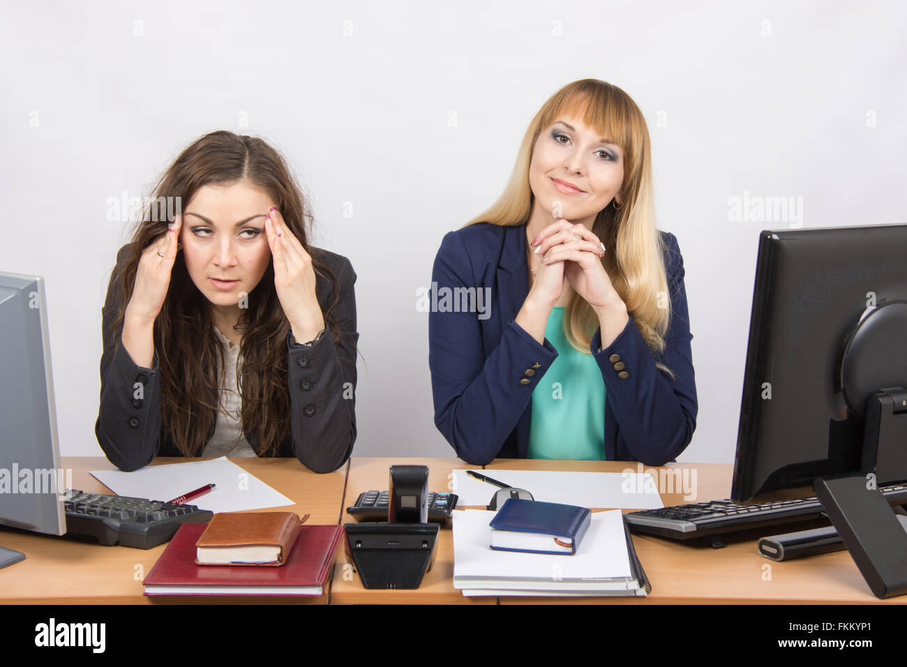 The situation in the office - the girl was very tired from his colleagues Stock Photo