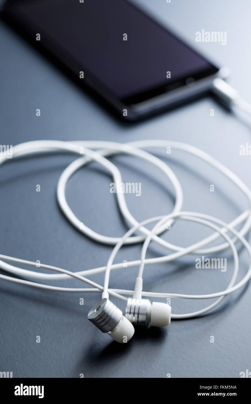 earphones and cellphone on black background Stock Photo