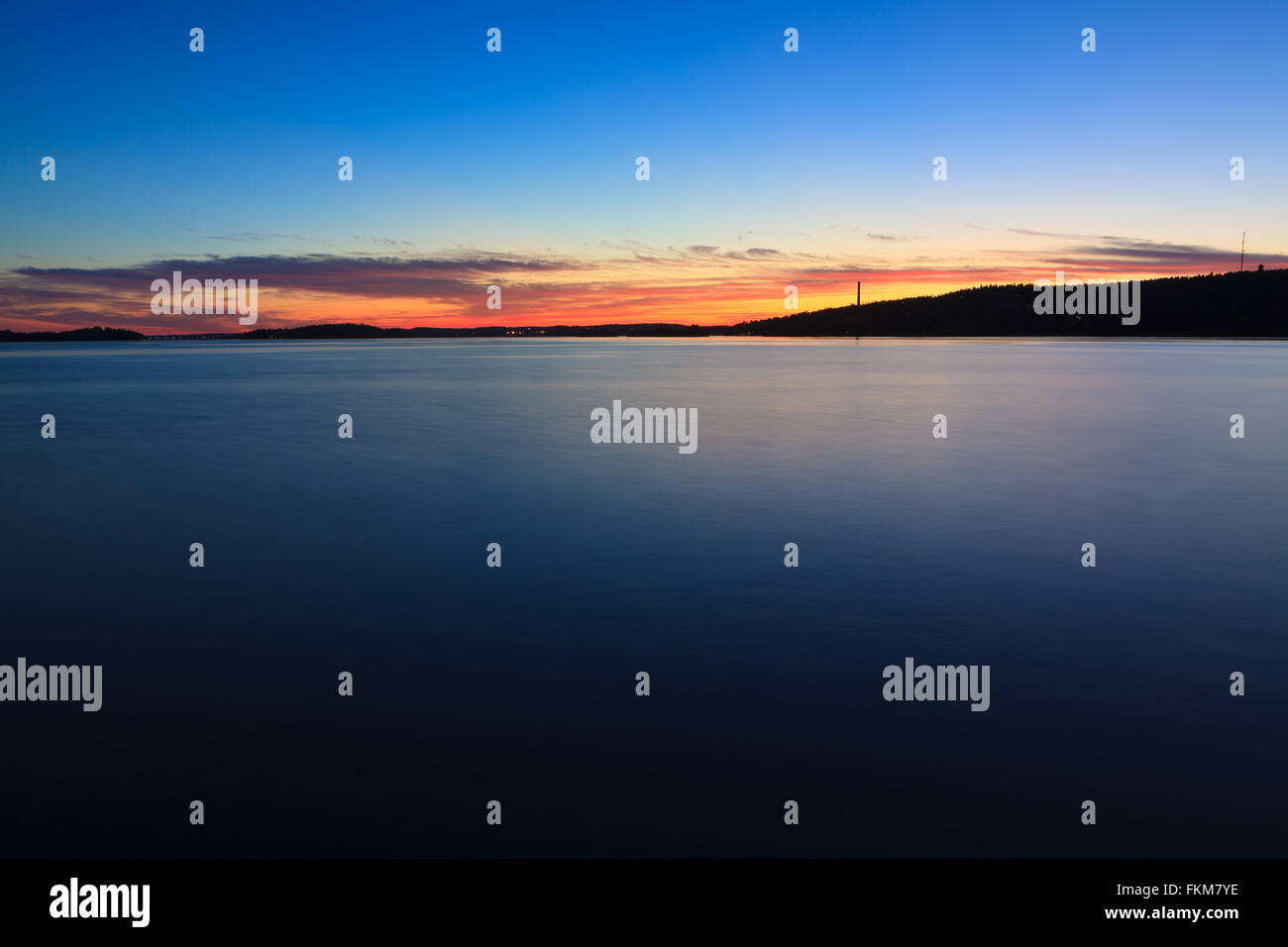 Calm sunset and clouds over lake Stock Photo - Alamy