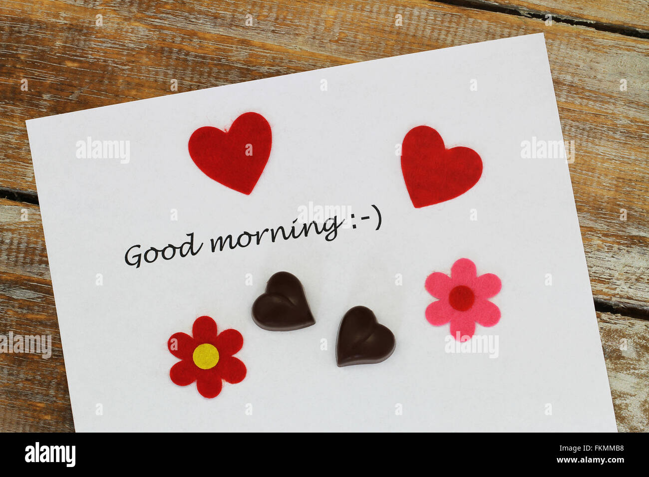 Good morning written on white paper with red hearts, heart shaped
