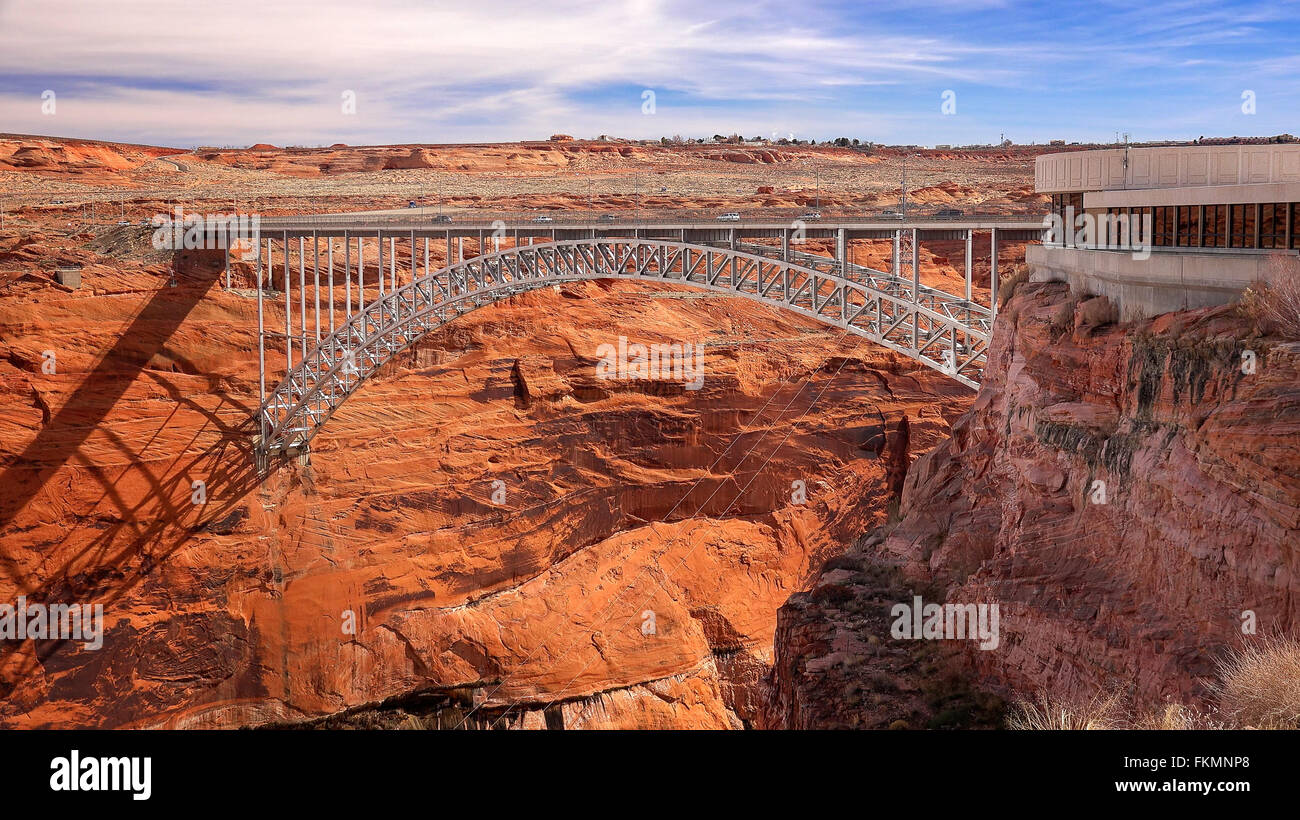 A steel arch bridge spans the canyon next to the Glen Canyon Dam visitor center in Page, Arizona Stock Photo
