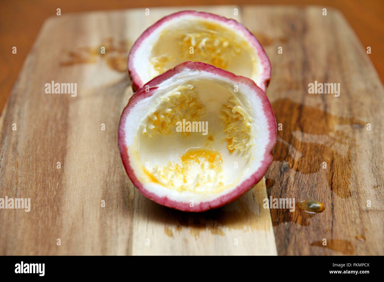empty passion fruit on chopping board Stock Photo