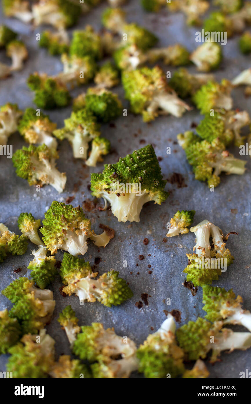 Roasted florets of Romanesco broccoli on a baking tray Stock Photo