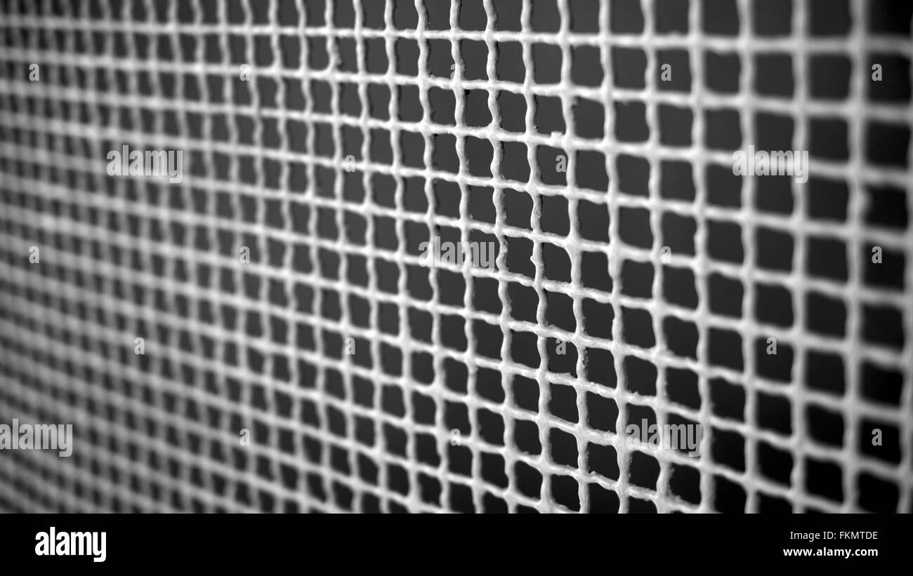Painted white metal grid with dark background Stock Photo