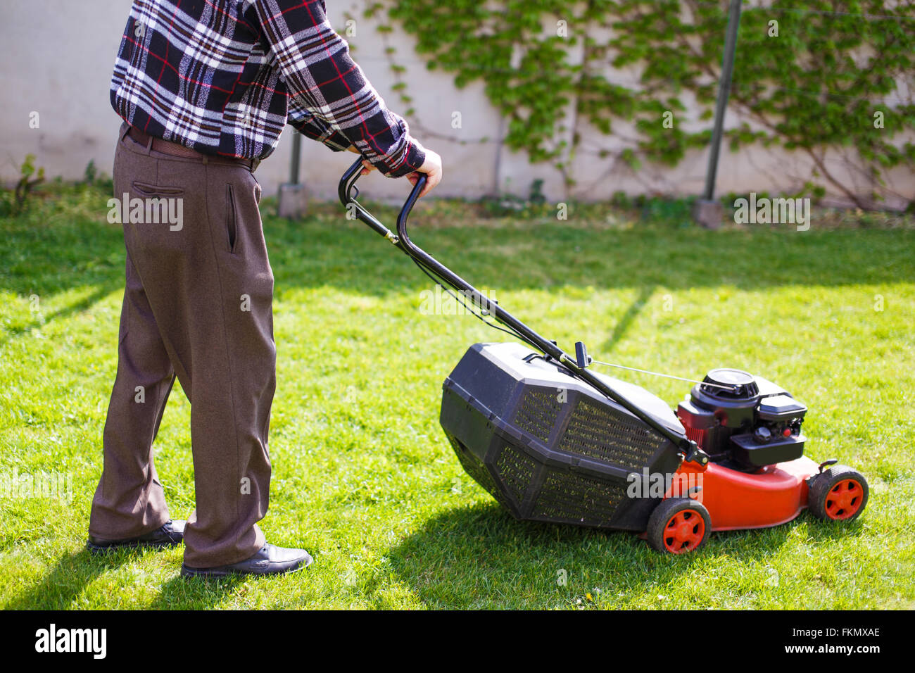 Senior mowing the lawn care home hi res stock photography and
