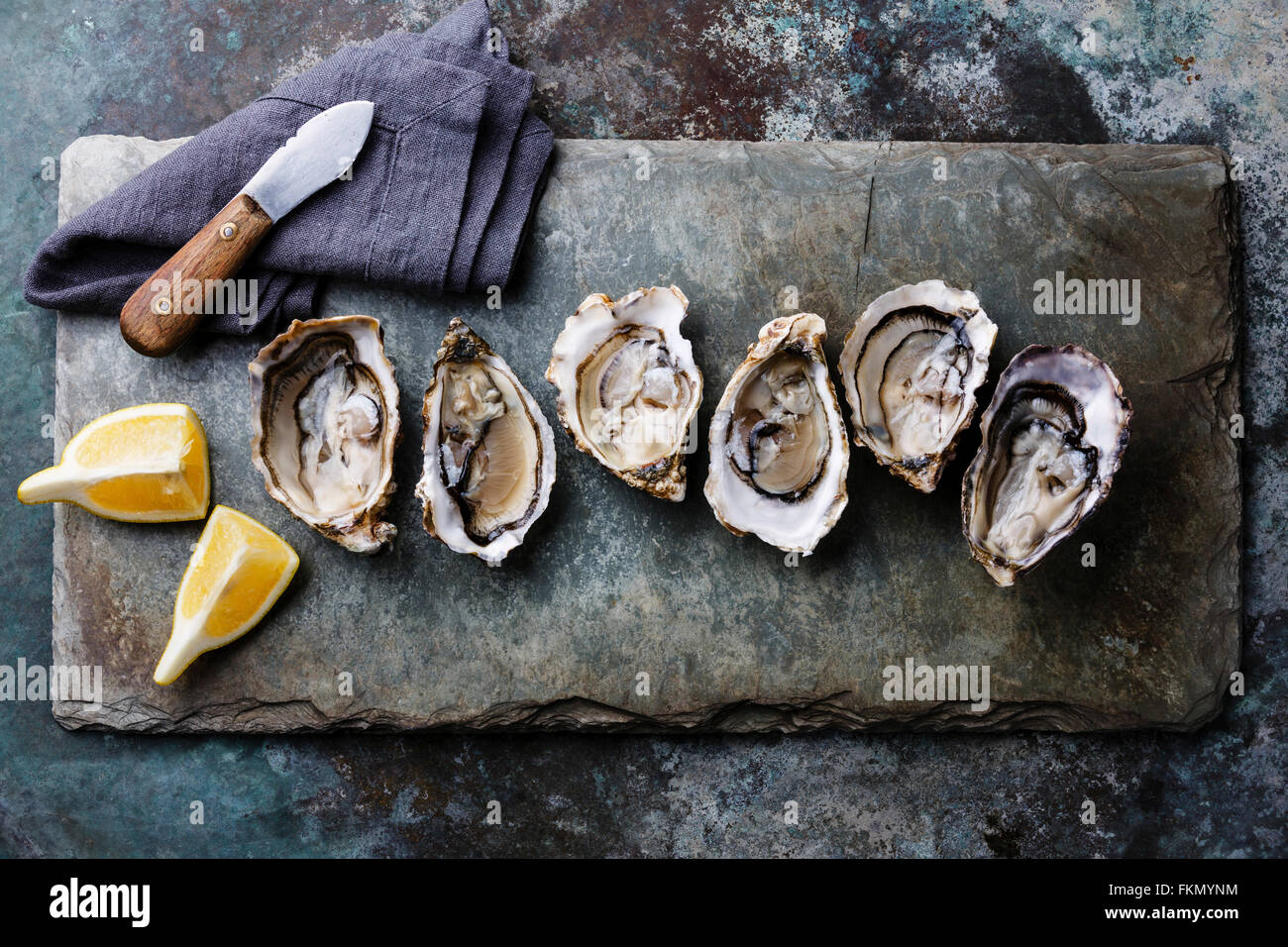 Open Oysters Fines de Claire on stone plate with lemon Stock Photo Alamy