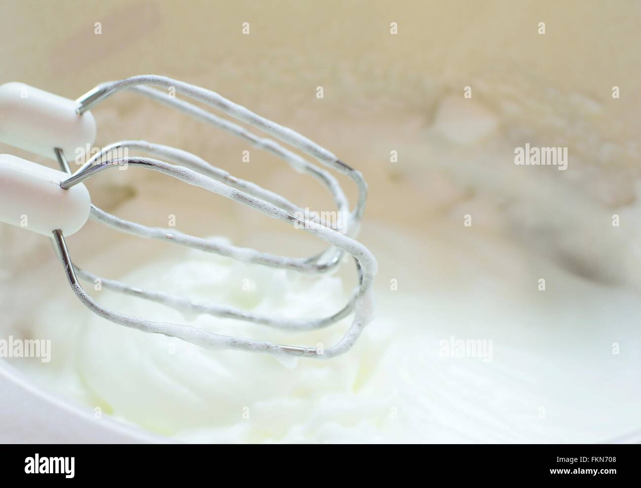 Whisk with egg white mixing into snow Stock Photo Alamy