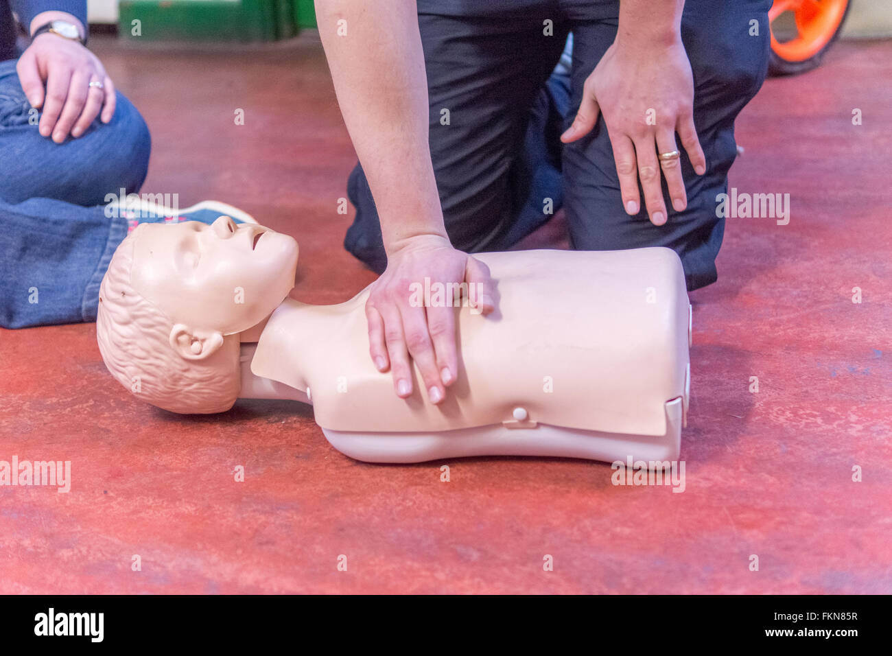 Parents and grandparents are given Basic Life Support (BLS) instruction PICTURED: position of heel of hand on chest prior to chest compressions. Stock Photo