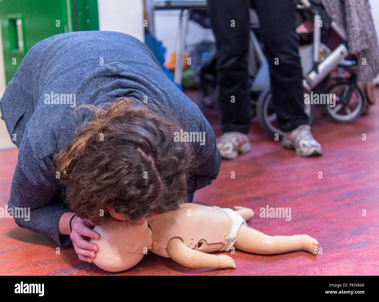 Parents and grandparents are given Basic Life Support (BLS) instruction. PICTURED: mouth to mouth technique. Stock Photo