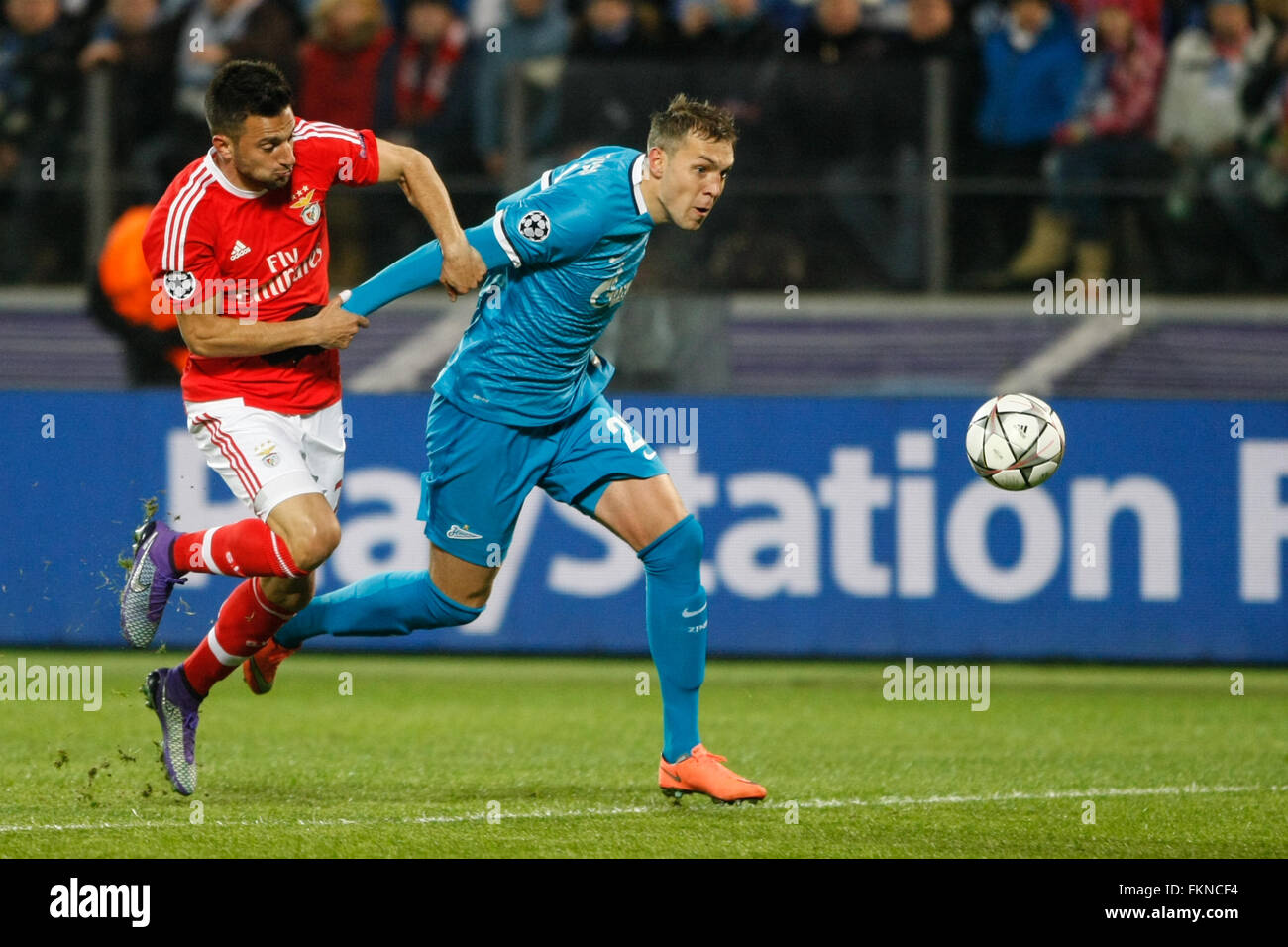 St. Petersburg, Russia. 9th March, 2016. Artem Dzyuba (R) of Zenit and Andreas Samaris of Benfica vie for the ball during the UEFA Champions League Round of 16 second leg match between FC Zenit St. Petersburg and SL Benfica at Petrovsky stadium. Credit:  Mike Kireev/Alamy Live News Stock Photo
