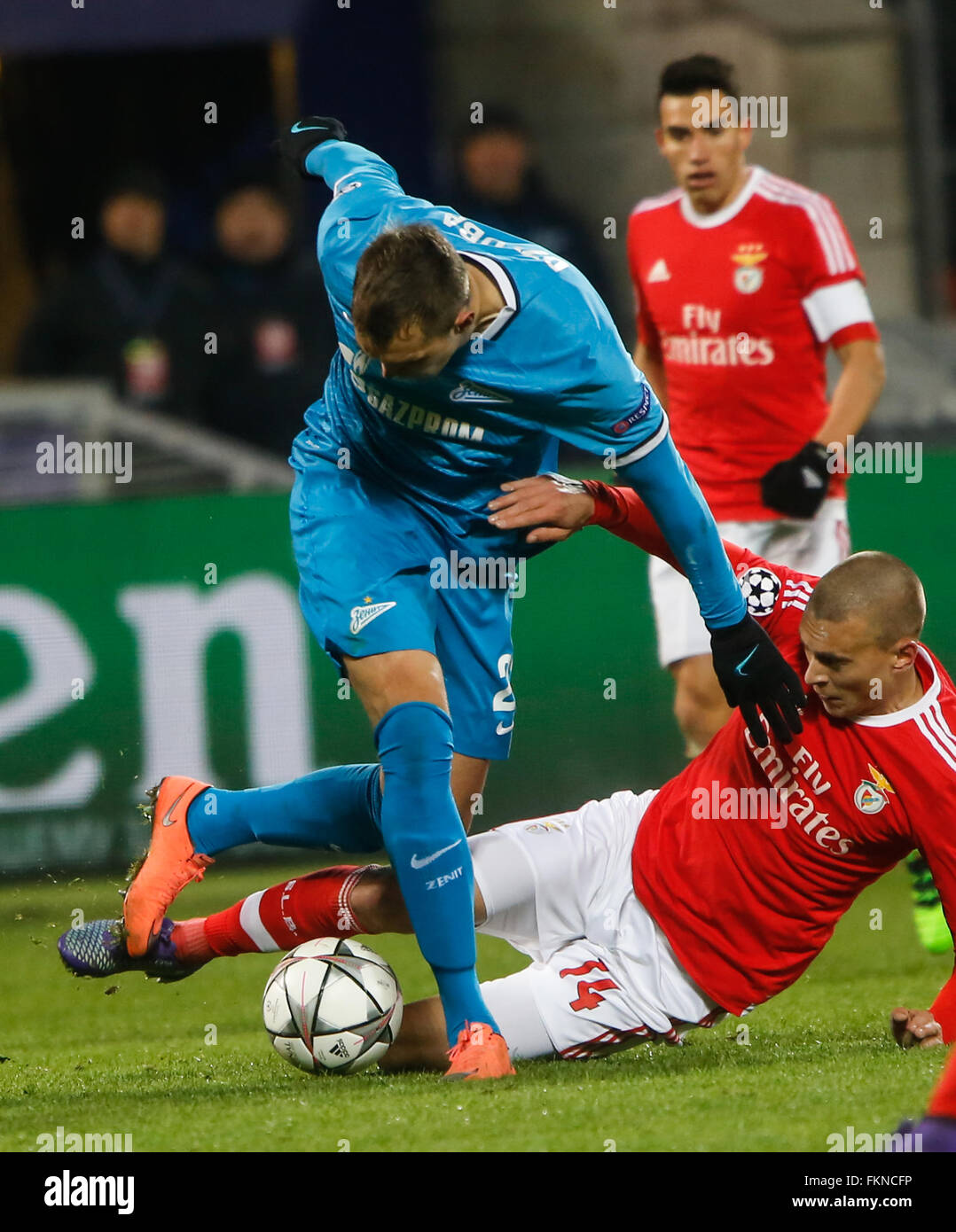 St. Petersburg, Russia. 9th March, 2016. Artem Dzyuba (L) of Zenit and Victor Lindelof of Benfica (N14) vie for the ball during the UEFA Champions League Round of 16 second leg match between FC Zenit St. Petersburg and SL Benfica at Petrovsky stadium. Credit:  Mike Kireev/Alamy Live News Stock Photo