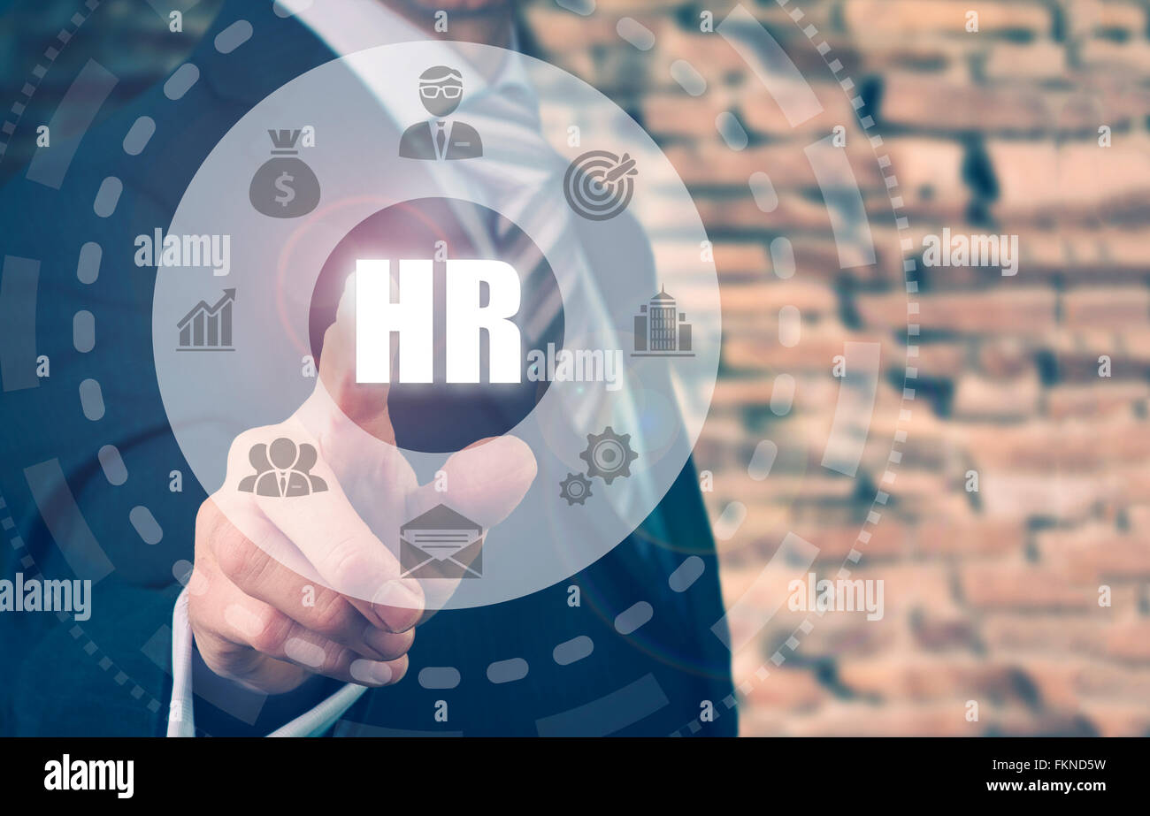 Businessman pressing a Human Resources concept button. Stock Photo