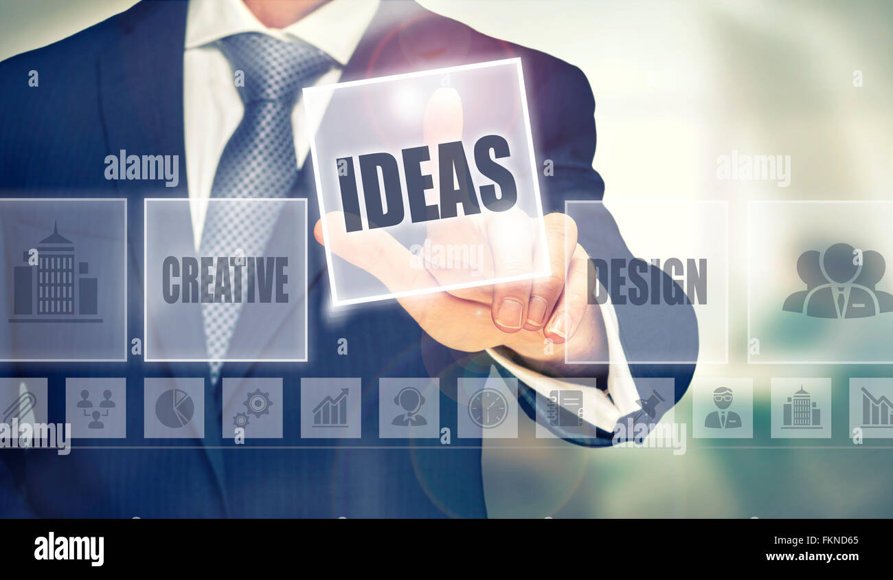 Businessman pressing a Ideas concept button. Stock Photo