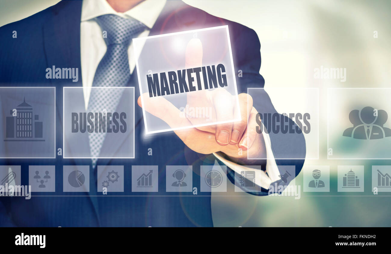 Businessman pressing a Marketing concept button. Stock Photo