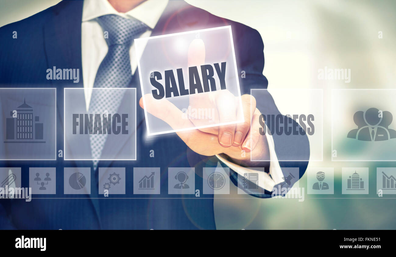 Businessman pressing an Salary concept button. Stock Photo