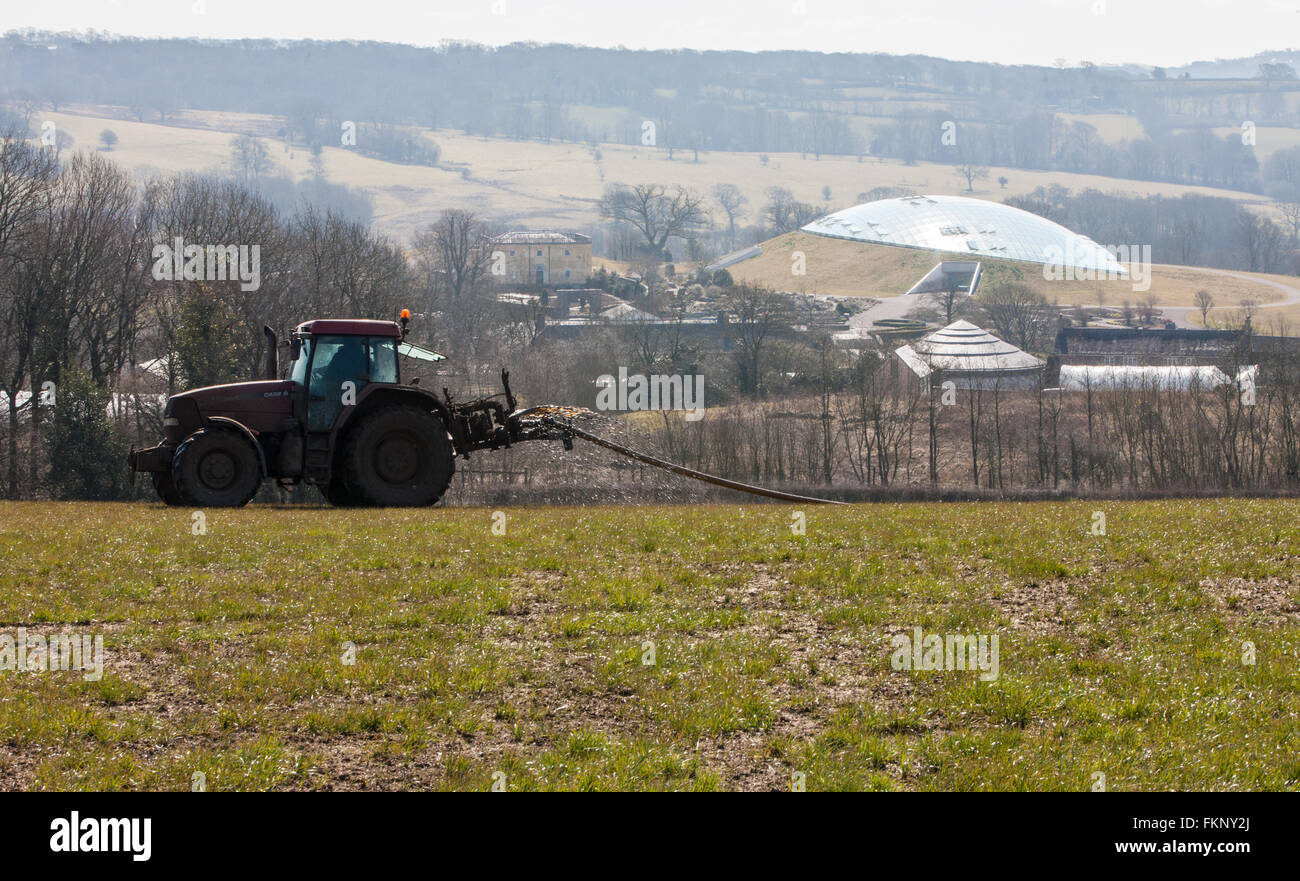 Tractor putting,spraying manure,muck spreading on field and National