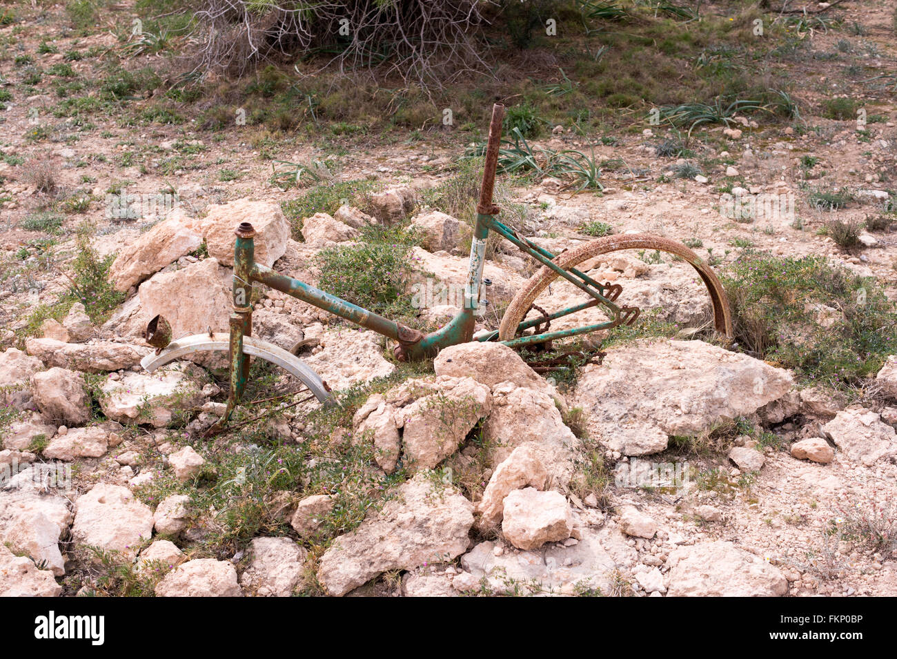 Discarded bike frame left to rust away in Spain Stock Photo