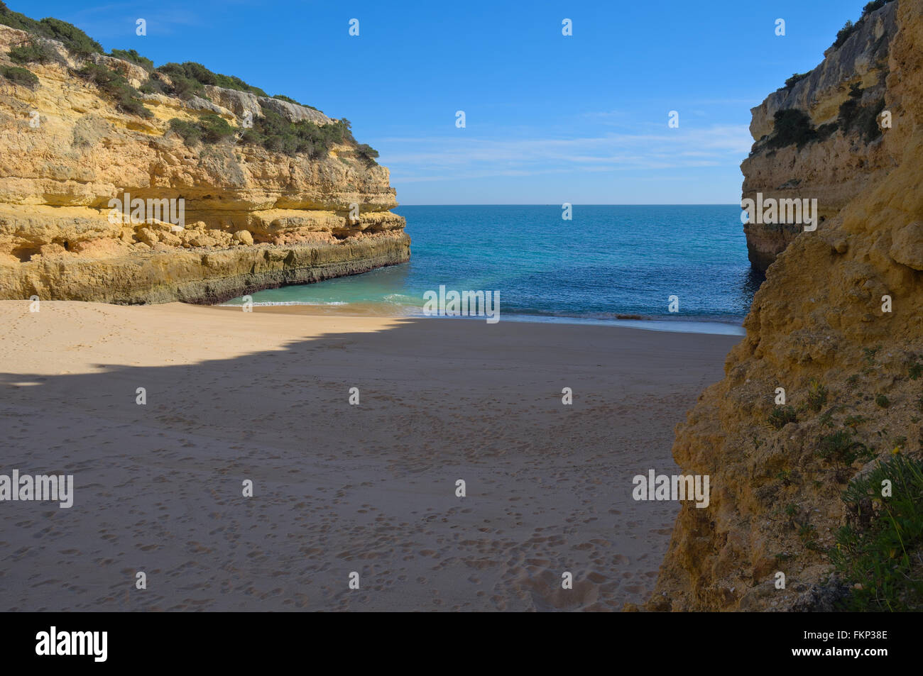 Beach waves lightly touching the sands in Fontainhas beach. Algarve