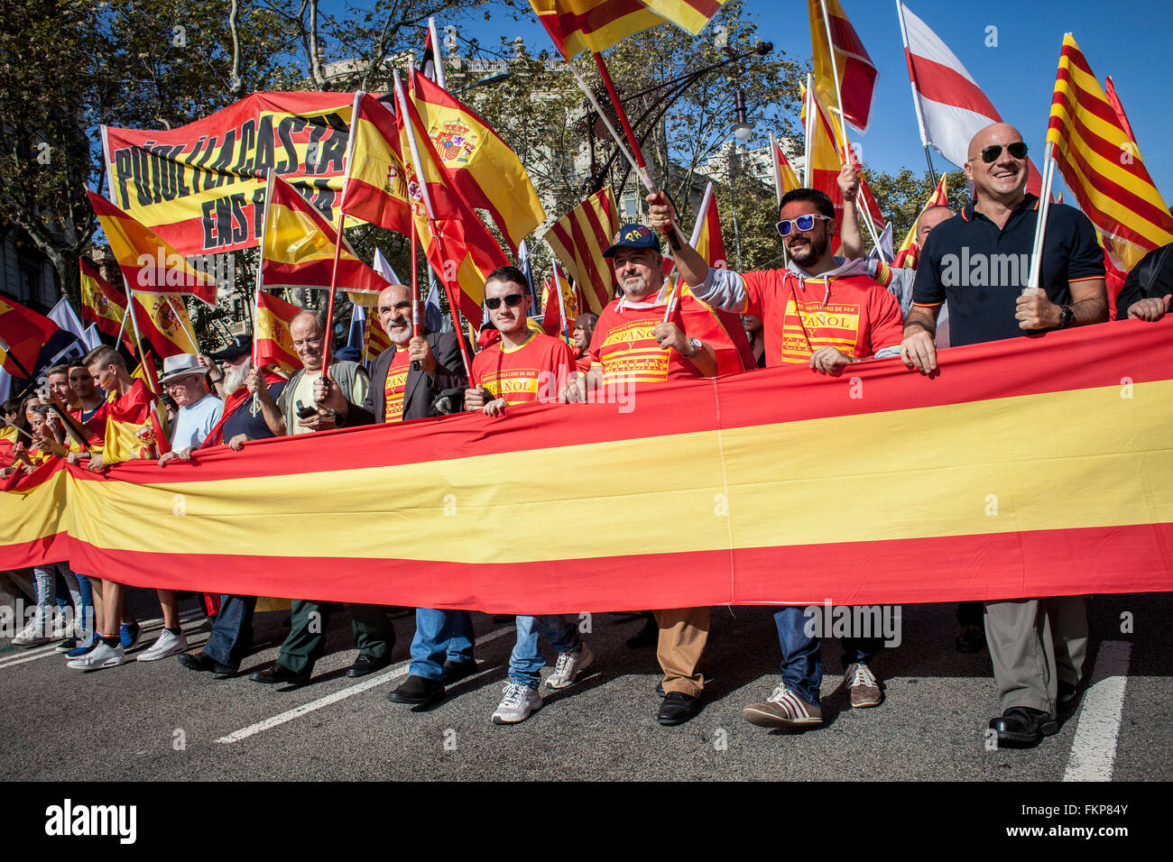 Anti-independence Catalan protestors carry Spanish flags and catalan flags during a demonstration for the unity of Spain on the Stock Photo