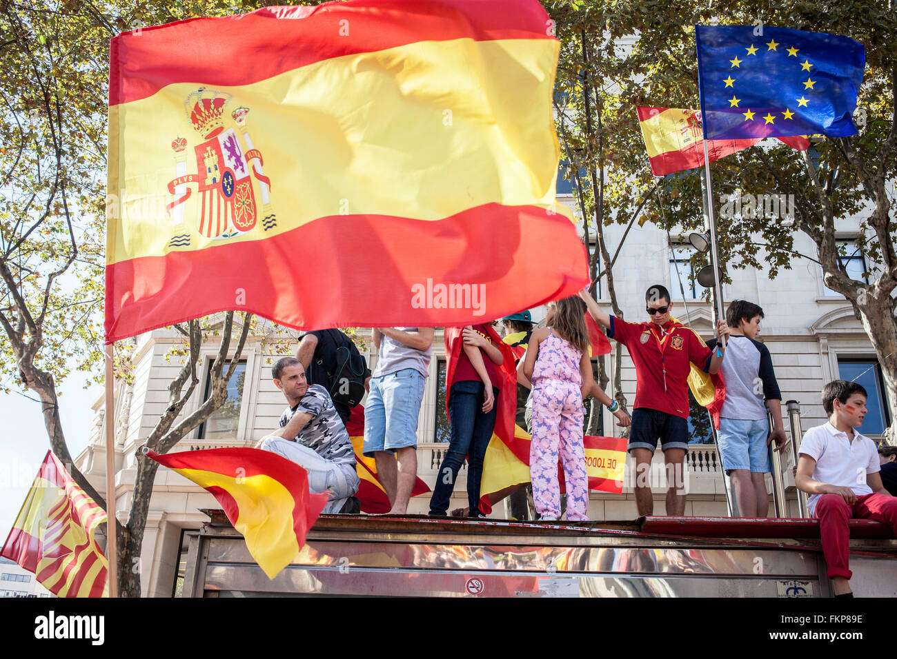 Anti-independence Catalan protestors carry Spanish flags during a demonstration for the unity of Spain on the occasion of the Sp Stock Photo