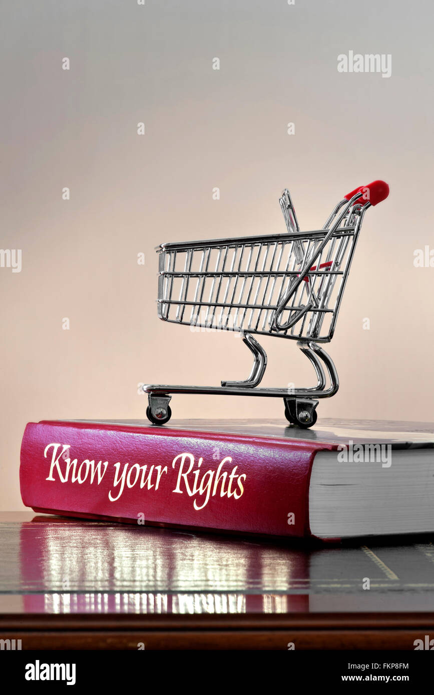 CONSUMER SHOPPING RIGHTS Legal concept of shopping trolley on 'Know your Rights' personal consumer protection legal advice book on leather bound desk Stock Photo