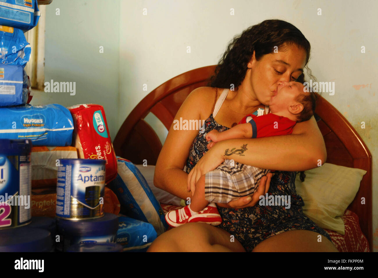 Rio De Janeiro, Brazil. 9th Mar, 2016. Poliana (L) holds her son Luiz Philipe (R), who was born with microcephaly, in their house in Marica, Rio de Janeiro state, Brazil, on March 9, 2016. Brazil will adopt the World Health Organization (WHO) standards from the next week to determine if a baby has microcephaly, the Brazilian Health Ministry said on Wednesday. © Estefan Radovicz/Agencia o Dia/AGENCIA ESTADO/Xinhua/Alamy Live News Stock Photo