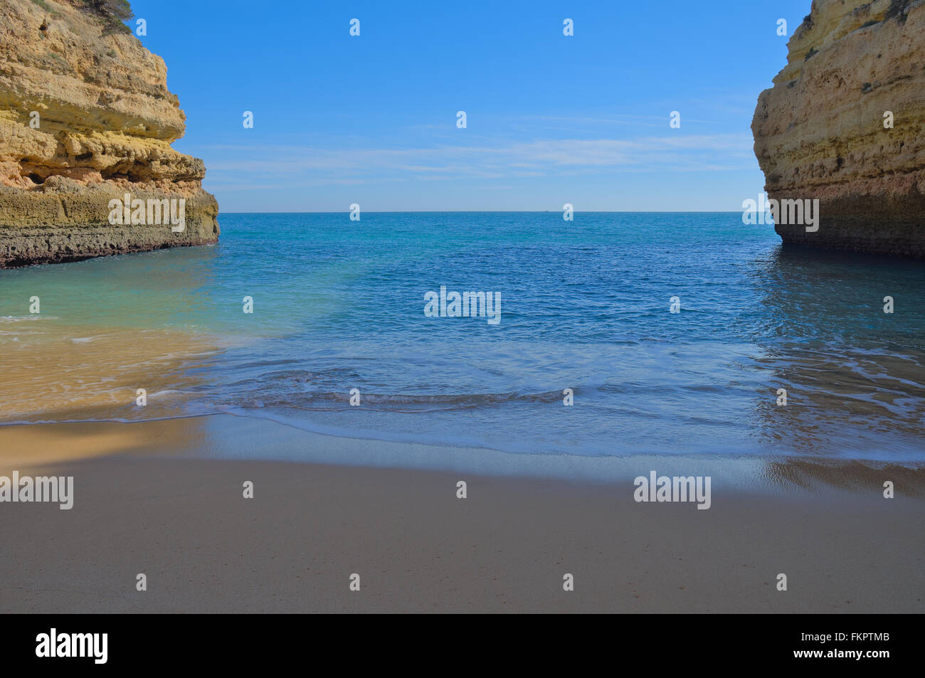 Beach waves lightly touching the sands in Fontainhas beach. Algarve