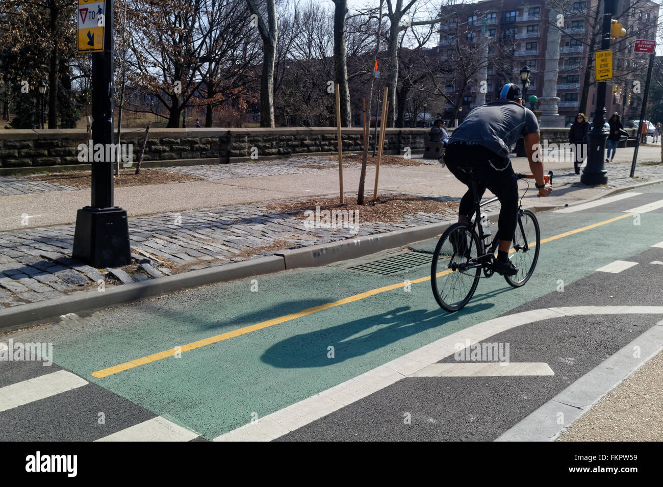 Cyclist zooming by on a city bike path. Stock Photo