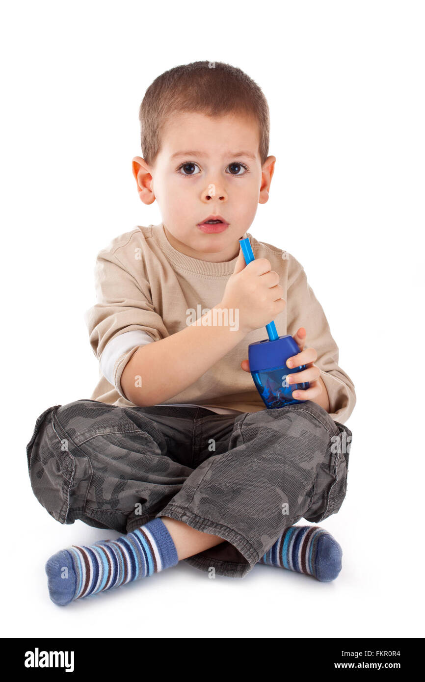 Little boy with pencil sharpener isolated on white Stock Photo