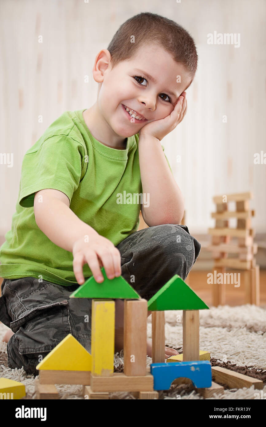 little boy building a house with colorful wooden blocks Stock Photo - Alamy