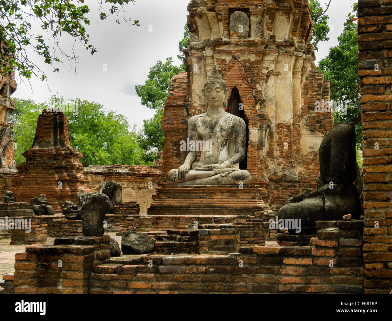 Temple buddha statue and ruins Wat Mahathat Ayutthaya Thailand Stock Photo