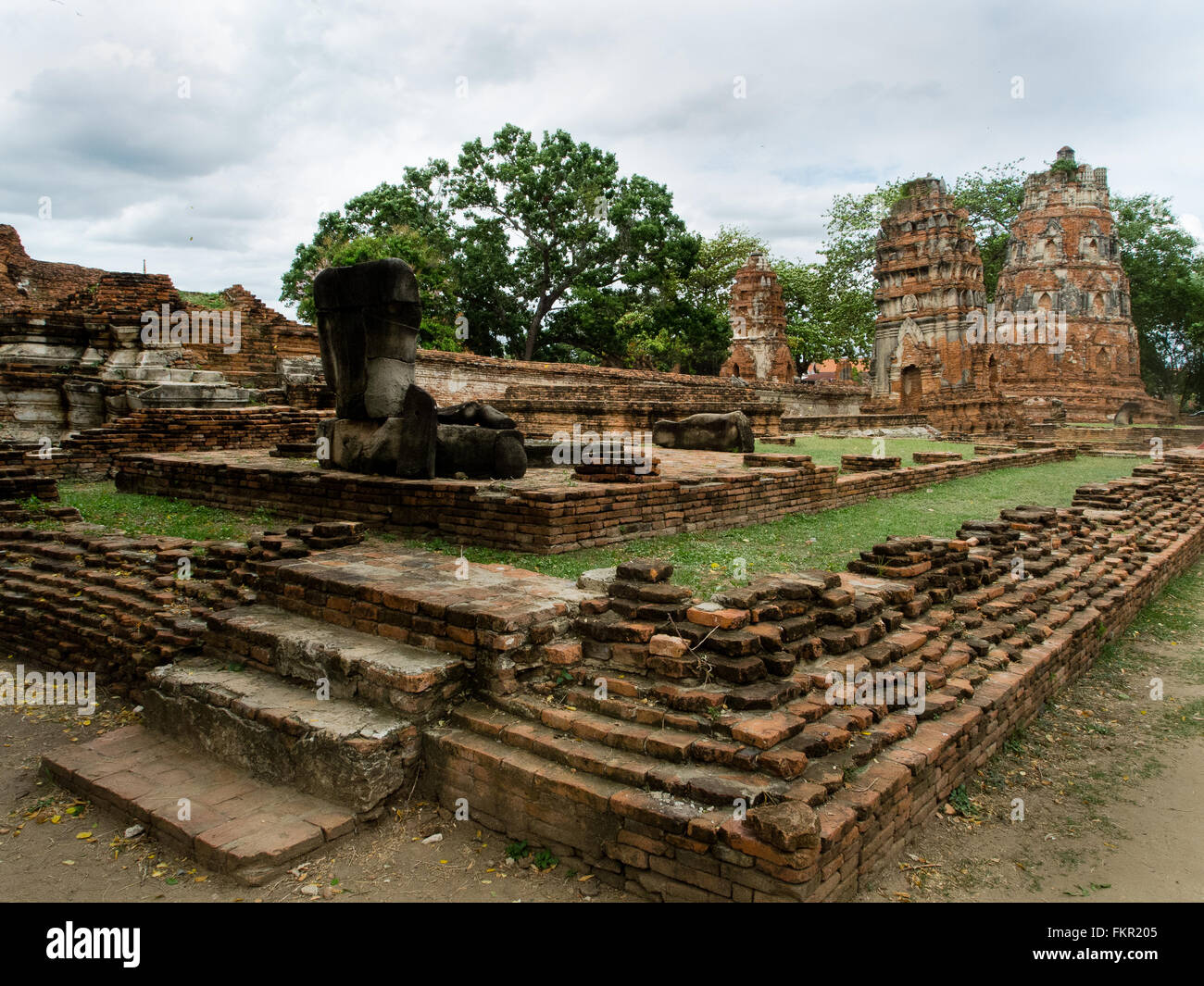 Temple buddha statue and ruins Wat Mahathat Ayutthaya Thailand Stock Photo