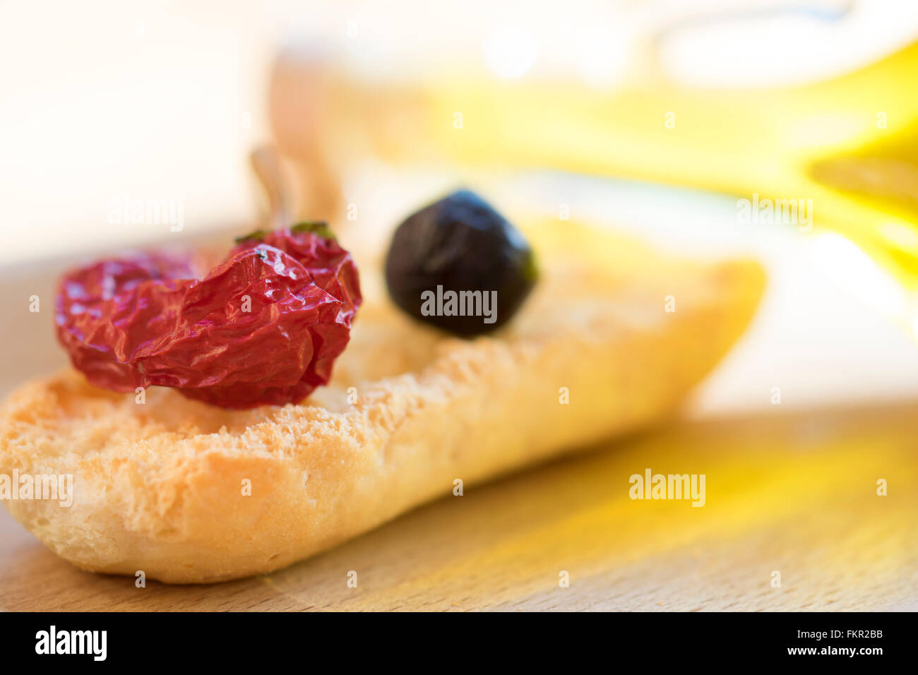 appetiser of toast hot pepper and a black olive Stock Photo