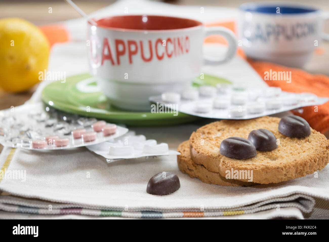 cappuccino rusks chocolate and blister pills at breakfast Stock Photo