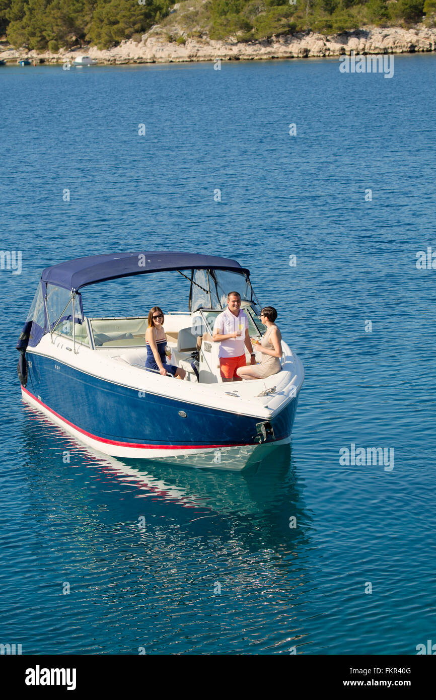 Friends relaxing on boat in ocean Stock Photo