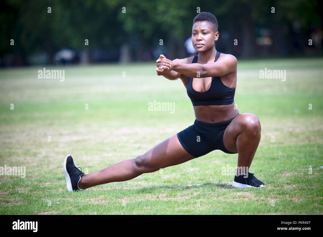 Athlete stretching in grass hi-res stock photography and images - Alamy