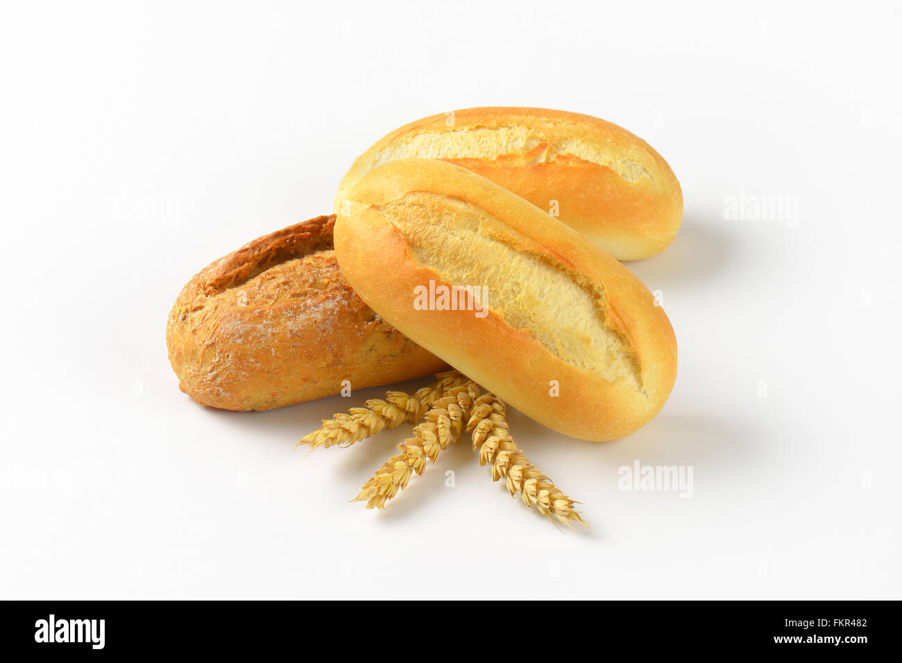 three freshly baked bread rolls on white background Stock Photo