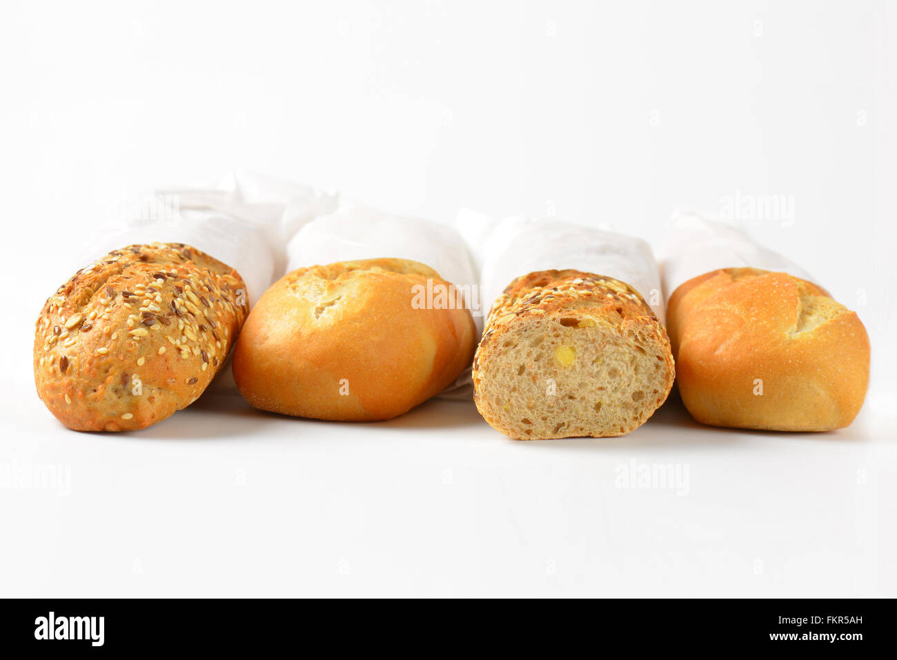 assorted baguettes in paper bags on white background Stock Photo - Alamy
