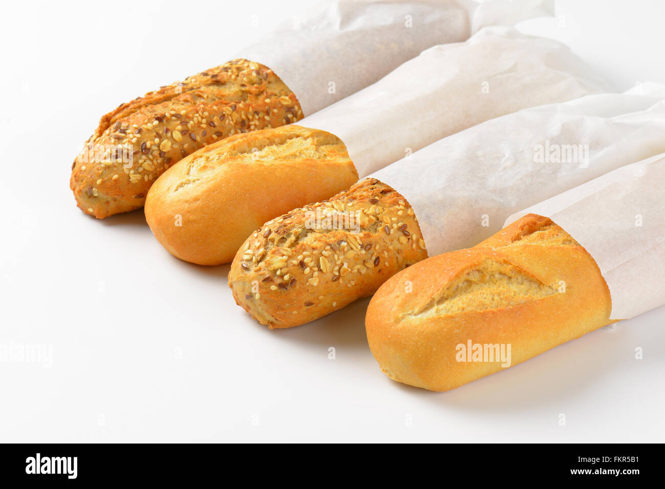 assorted baguettes in paper bags on white background Stock Photo - Alamy