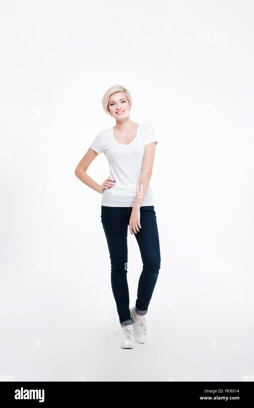 Full length portrait of a casual happy woman standing isolated on a ...