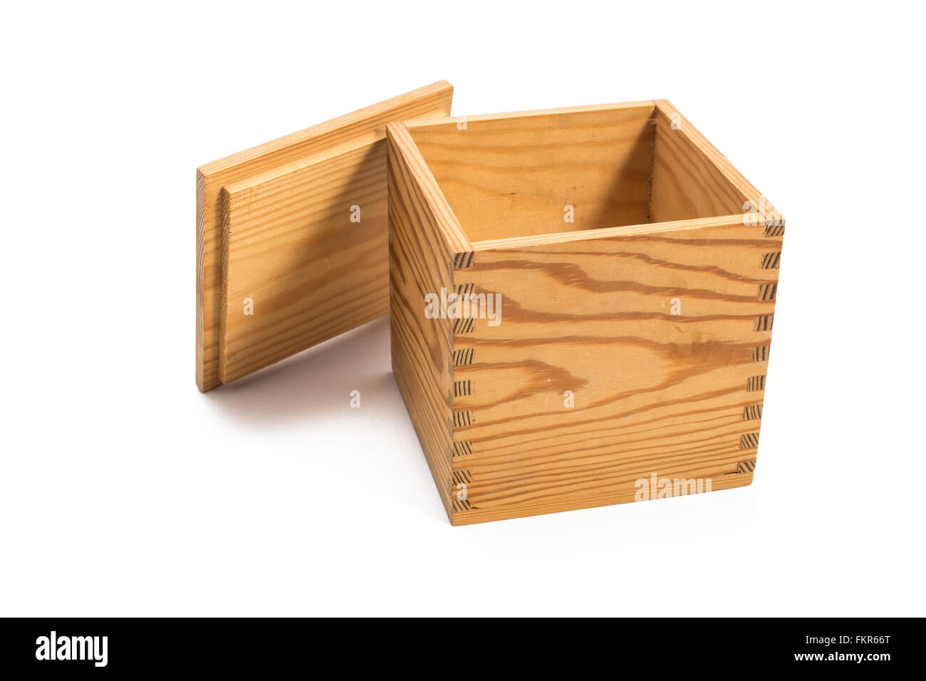 small empty box joined wood box with a perfectly fitted lid leaning up against the side of the box Stock Photo