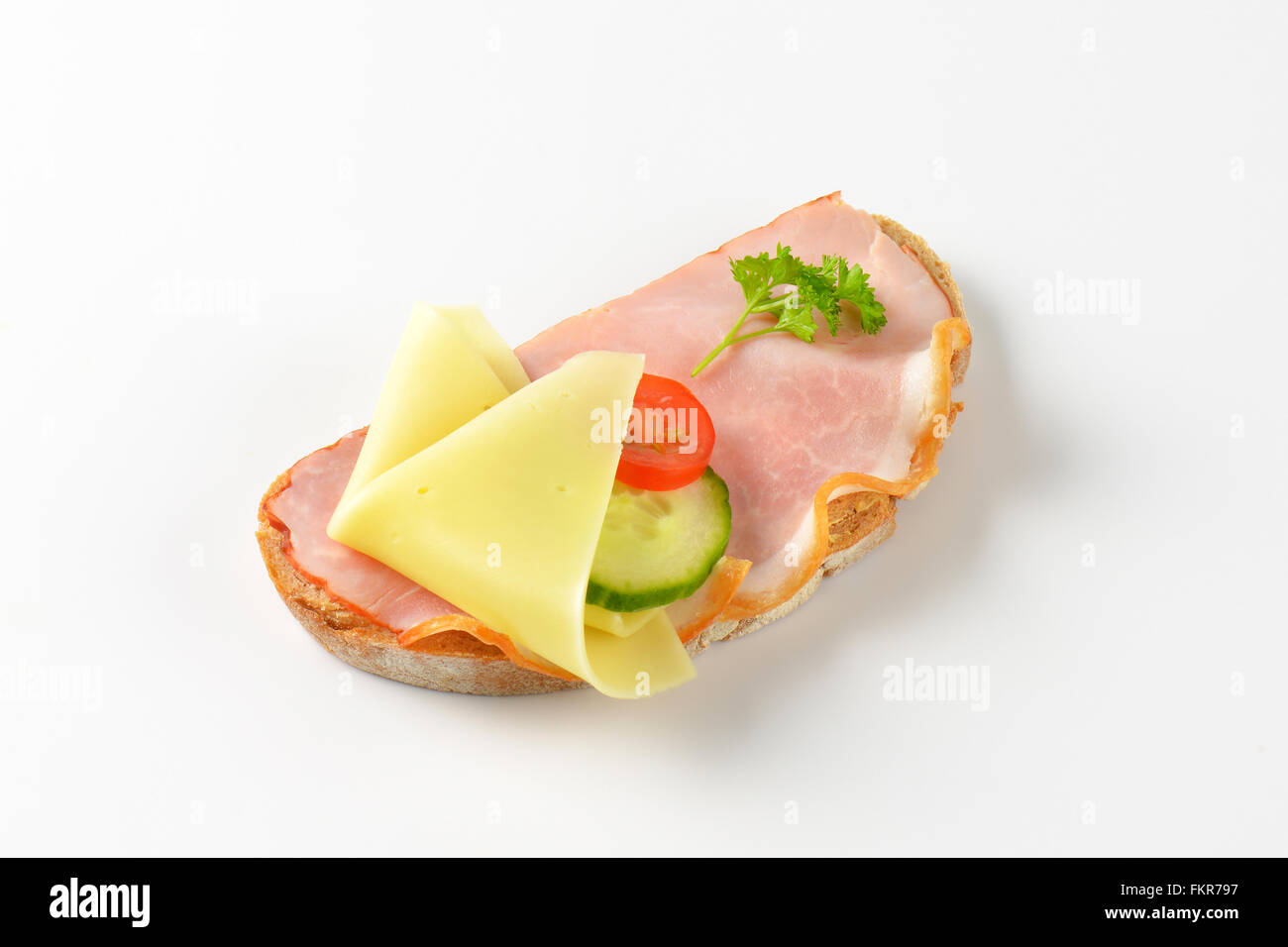 open faced sandwich with ham and cheese on white background Stock Photo