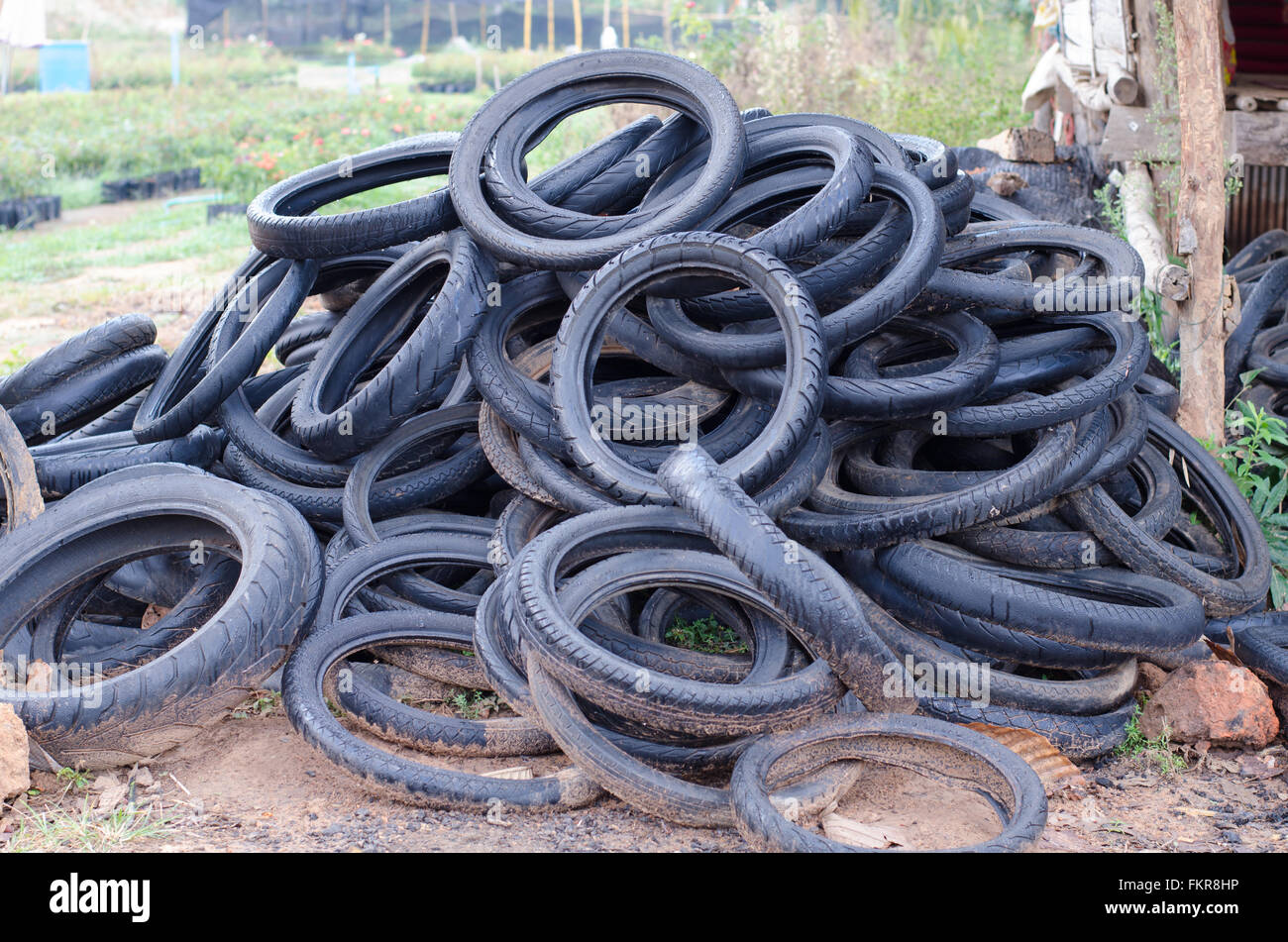 Pile of used rubber tyres on the floor Stock Photo