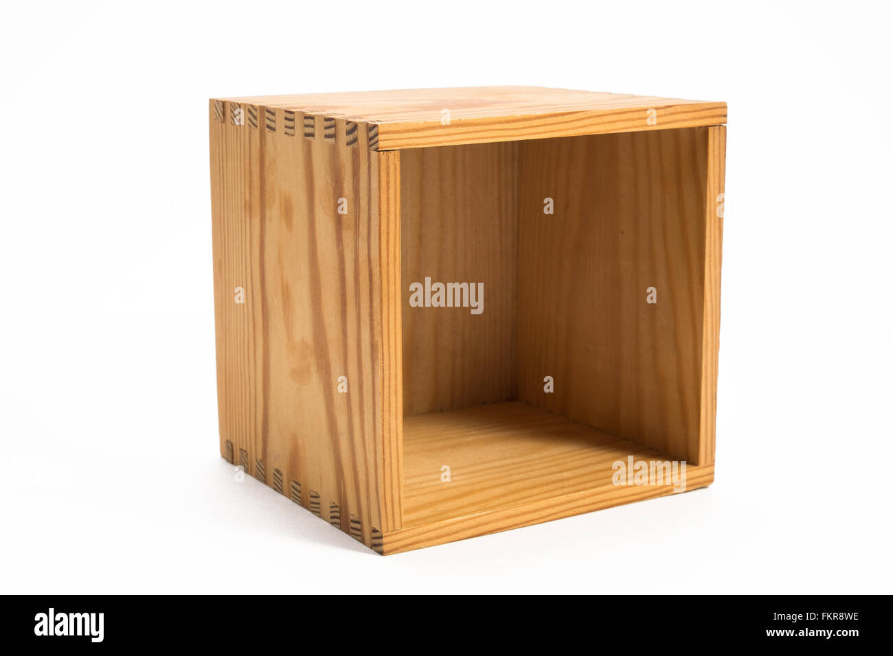 box of wood standing on a side on white surface, the opening is facing front, as you can look in to the empty box Stock Photo