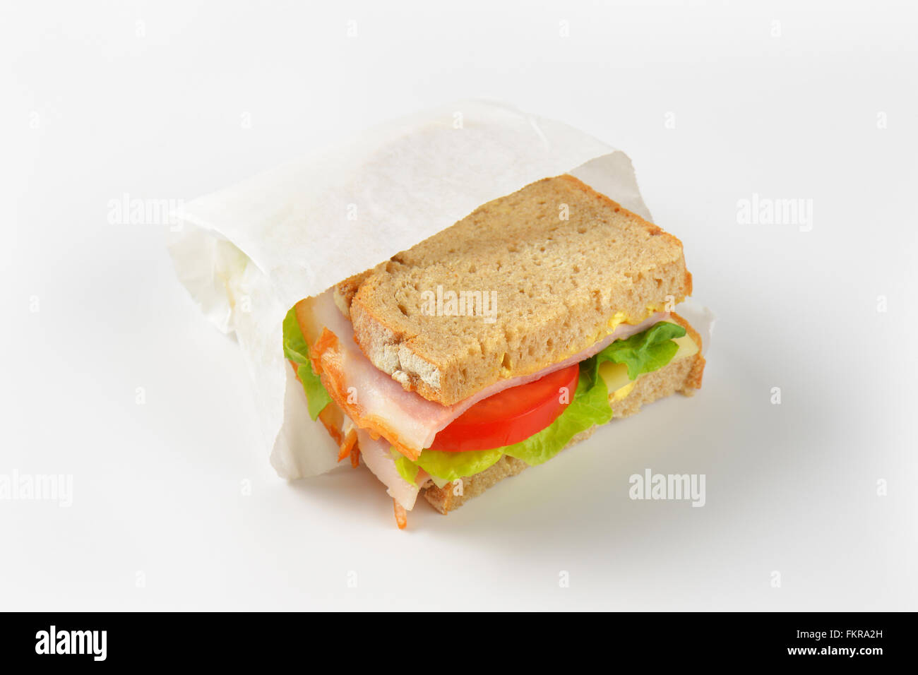 https://c8.alamy.com/comp/FKRA2H/fresh-sandwich-with-ham-cheese-and-vegetables-in-paper-bag-FKRA2H.jpg
