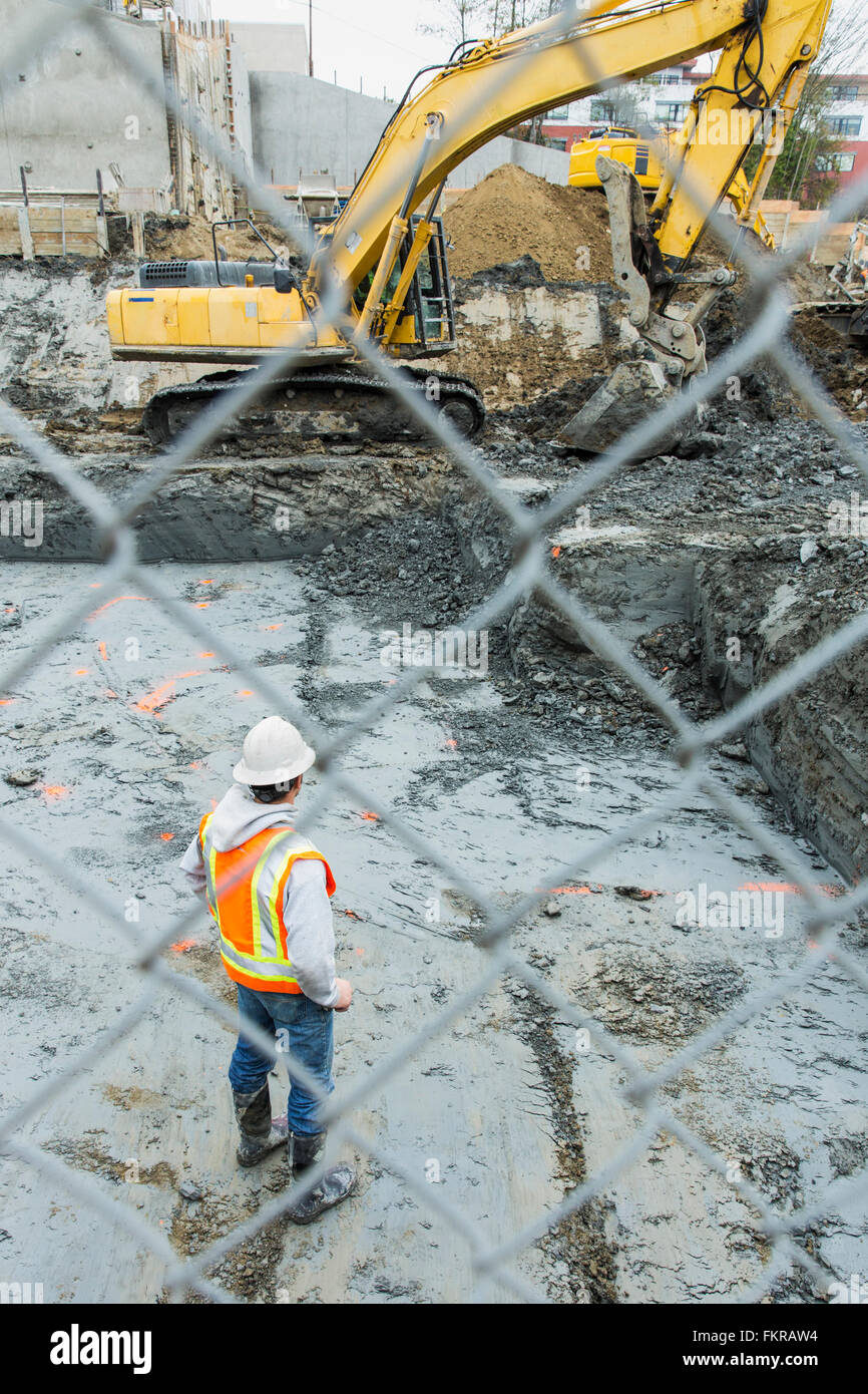 Caucasian worker standing at construction site Stock Photo